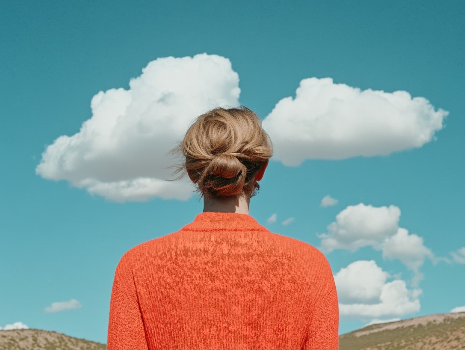 Woman in front of bright blue sky